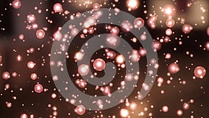 Floating bubbles of pink light in dark background