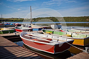 Floating Color Wooden Boats with Paddles in a Lake