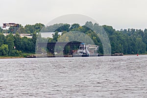Floating Construction crane on platform near the shore of the Volga river in Russia