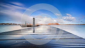 Floating curved pier on a dutch lake