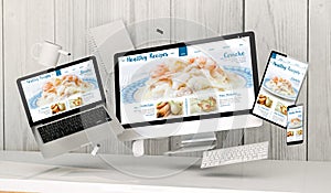 floating devices at the office with healthy recipes blog on screen