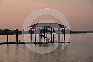 Floating dock with boat house and slide at sunset