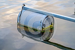 floating dock buoy with moss and reflection..