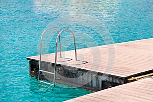 Floating dock with composite deck and ladder at the marina
