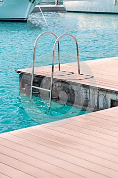 Floating dock with composite deck and ladder at the marina