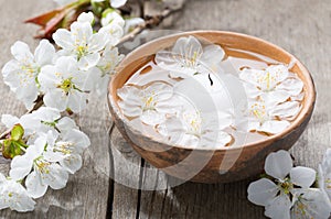 Floating flowers ( Cherry blossom) and burning candle.