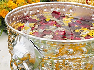 Floating flowers and fragrant water in a zinc bowl