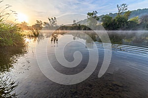 Floating fog on summer morning river surface