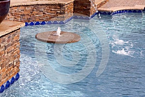 Floating fountain within a swimming pool