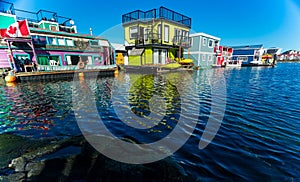 Floating Home Village colorful Houseboats Water Taxi Fisherman`s Wharf Reflection Inner Harbor, Victoria British Columbia Canada