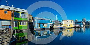 Floating Home Village Houseboats Fisherman`s Wharf Inner Harbor, Victoria British Columbia Canada.Area has floating homes, boats,