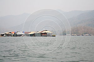 Floating house or raft house in the lake landscap with mountains