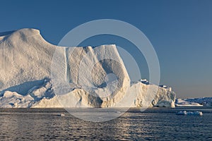 Floating icebergs in Disko Bay during the midnight sun