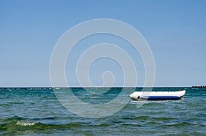 Floating inflatable  white-blue  banana   boat ride  near seashoire