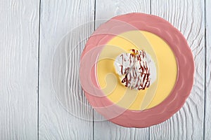 Floating island dessert in a pink plate