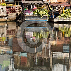 Floating market with reflection in water at Mekong river