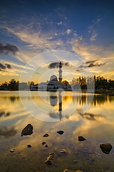 Floating mosque located in Kuala Ibai, Terengganu Malaysia over stunning sunset background photo