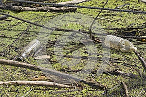 Floating old garbage in water, plastic bottles