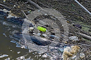 Floating old garbage in water, plastic bottles