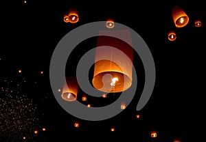 Floating paper lantern in night sky photo