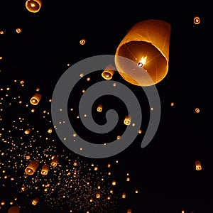 Floating paper lantern in night sky photo