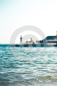 Floating platform in the sea, with teenagers having fun, out of focus