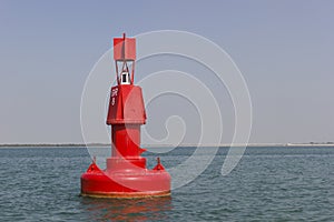 Floating red navigational buoy