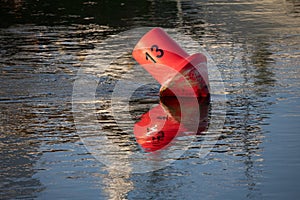Floating red navigational buoy in the Neris River