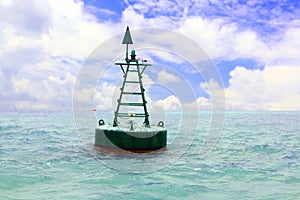 Floating red navigational buoy in open sea