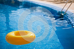 Floating ring on blue water swimpool