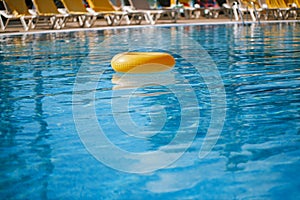 Floating ring on blue water swimpool