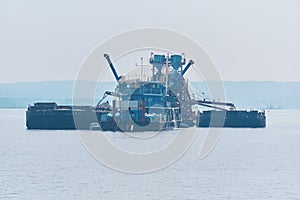 Floating sand mining plant - dredger and separator - on the river