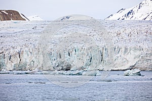 Floating sea ice in front of massive glacier in arctic