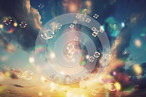 Floating soap bubbles and a sunset sky.