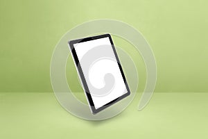 Floating tablet pc computer isolated on green. Horizontal background