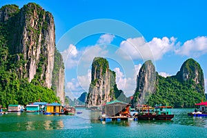 Floating village, rock island, Halong Bay, Vietnam photo