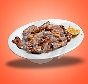Floating White plate with Spare ribs and lemon