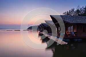 Floating wooden house againts sky in dam