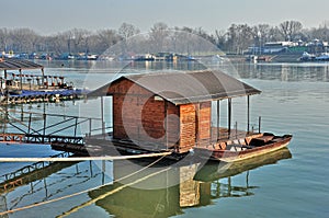 Floating wooden house with boat