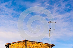 Flock of Laundress birds on a TV antenna of a stone building