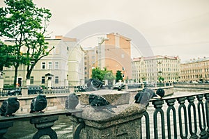 flock of pigeons sitting on the cold river railing city street