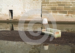 Flood desaster with furniture on an island in the water