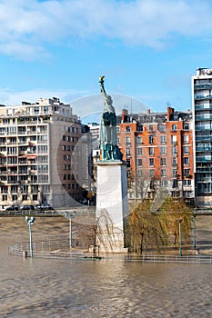 Flood of the Seine river in Paris near Statue of Liberty replica