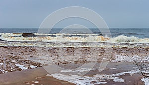 Flood under thin ice in front of winter lake