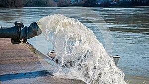 Flood water being pumped from pump station photo