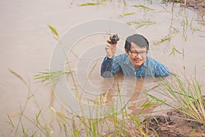 Flood water in ric field and pond, Farmer men working in nature water pond  of rice paddy field