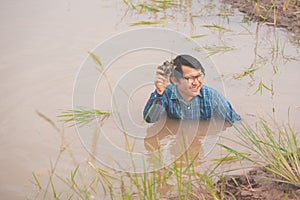 Flood water in ric field and pond, Farmer men working in nature water pond  of rice paddy field