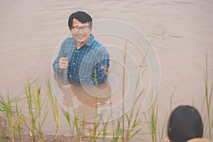 Flood water in ric field and pond, Farmer men working in nature water pond  of rice paddy field