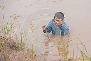 Flood water in ric field and pond, Farmer men working in nature water pond  of rice paddy field