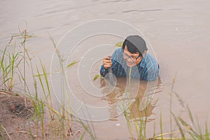 Flood water in ric field and pond, Farmer men working in nature water pond  of rice paddy field